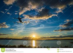 airplane-climbs-flying-over-sea-towards-sun-sunset-105207563.jpg
