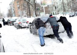 guys-pushing-car-stuck-snow-600w-132741215.jpg